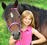 A girl with a horse that wears a english bridle